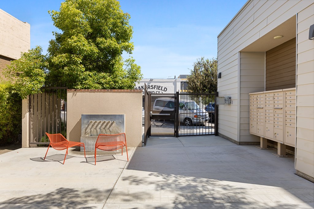 A small courtyard with a bench and a fence.